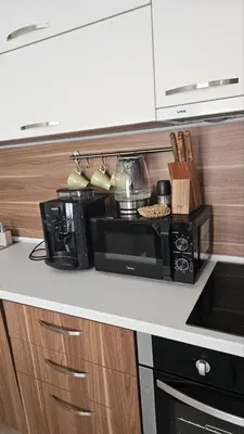 a kitchen counter with a microwave on a counter top at Vladan apartments in Sozopol