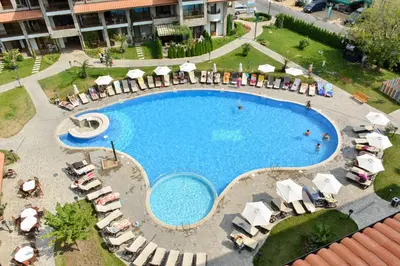an overhead view of a swimming pool with chairs and umbrellas at Private Apartments Olymp in Sveti Vlas