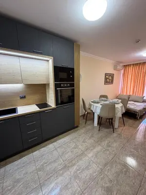 a living room with a kitchen and a dining room at Private Apartments Olymp in Sveti Vlas