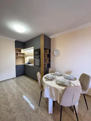 a dining room with a white table and chairs at Private Apartments Olymp in Sveti Vlas