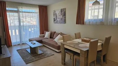 a living room with a couch and a table at Vladan apartments in Sozopol