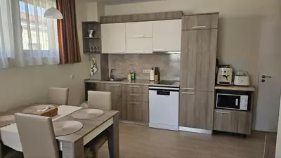 a kitchen with a table and a dining room at Vladan apartments in Sozopol