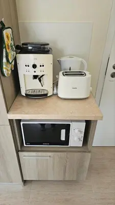 a counter with a microwave and a toaster oven on it at Vladan apartments in Sozopol
