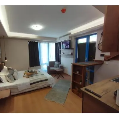 a bedroom with a bed and a desk in a room at Cozy private studios Excelsior Sunny Beach in Sunny Beach