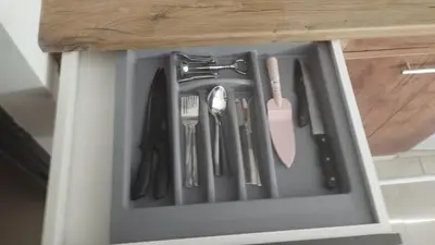a drawer filled with utensils in a cabinet at Cozy private studios Excelsior Sunny Beach in Sunny Beach