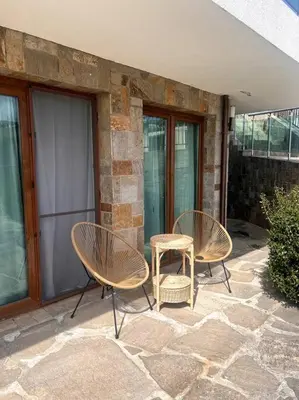 two chairs and a table on a patio at Panorama Bay-Serenity Haven in Burgas City
