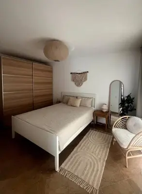 a bedroom with a white bed and a chair at Panorama Bay-Serenity Haven in Burgas City