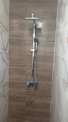 a shower in a bathroom with a shower head at Синя пеперуда Blue butterfly in Primorsko