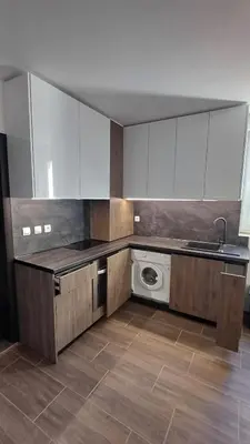 a kitchen with white cabinets and a washing machine at Синя пеперуда Blue butterfly in Primorsko