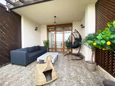 a living room with a couch and a table at Santa Marina Sun&Sea Haven in Sozopol