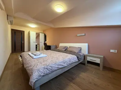 a bedroom with a large bed in a room at Two-Bedroom Apartment in the Heart of Burgas, Bogoridi Street in Burgas City