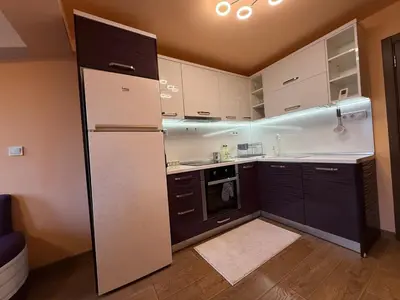 a kitchen with white cabinets and a refrigerator at Two-Bedroom Apartment in the Heart of Burgas, Bogoridi Street in Burgas City
