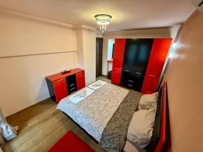 a small bedroom with a bed and a red cabinet at Two-Bedroom Apartment in the Heart of Burgas, Bogoridi Street in Burgas City
