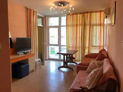 a living room with a couch and a tv at Elit 2 Apartment in Sunny Beach