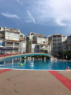 a swimming pool with a bridge and some buildings at Elit 2 Apartment in Sunny Beach