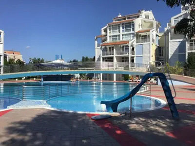 a swimming pool with a slide in front of a building at Elit 2 Apartment in Sunny Beach