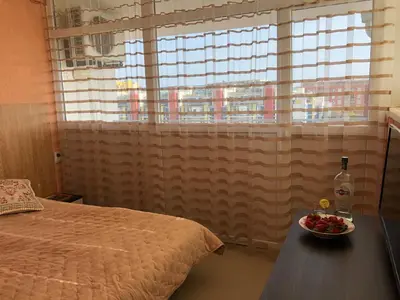 a bedroom with a bed and a bowl of fruit on a table at Elit 2 Apartment in Sunny Beach