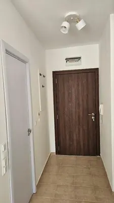 a hallway with a wooden door in a room at Vladan apartments in Sozopol