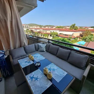 a living room with a couch and a table at Vladan apartments in Sozopol