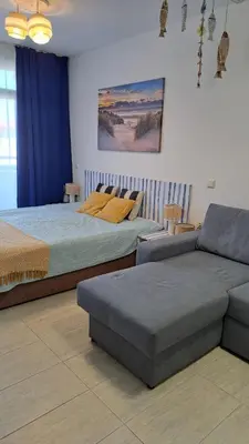 two beds and a couch in a room at Vladan apartments in Sozopol
