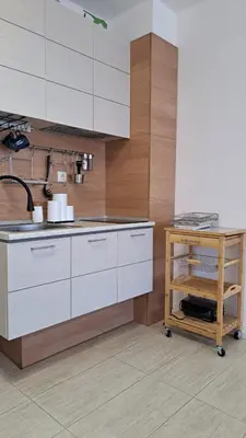 a kitchen with white cabinets and a sink at Vladan apartments in Sozopol