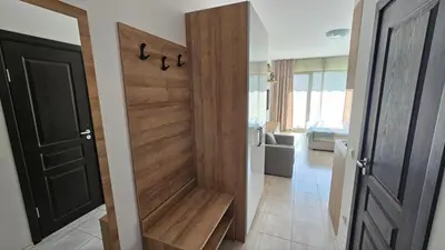 a wooden door in a room with a hallway at Vladan apartments in Sozopol
