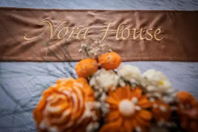 a sign that says word house next to a bouquet of flowers at Apartment NORA in Sunny Beach