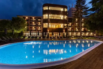a swimming pool in front of a building at night at Noma Boutique Hotel - Adults only in Sunny Beach