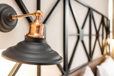 a bell hanging on a wall next to a bed at Noma Boutique Hotel - Adults only in Sunny Beach