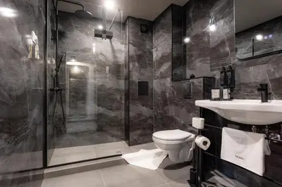 a bathroom with a shower and a toilet and a sink at Noma Boutique Hotel - Adults only in Sunny Beach