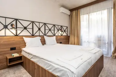 a large bed in a room with a large window at Noma Boutique Hotel - Adults only in Sunny Beach
