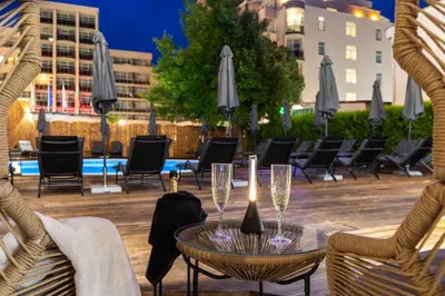 a patio with chairs and a table with wine glasses at Noma Boutique Hotel - Adults only in Sunny Beach