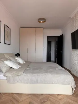 a bedroom with a large bed with white sheets at SeaView Etara IV Apartment in Sveti Vlas in Sveti Vlas
