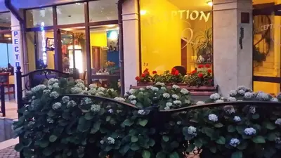 a store with flowers in front of it at Hotel Continental in Kiten
