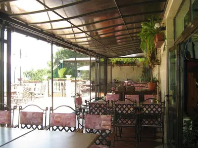 a patio with a table and chairs and a table and chairsktop at Hotel Continental in Kiten