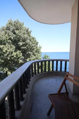 a balcony with a bench and the ocean in the background at Hotel Continental in Kiten