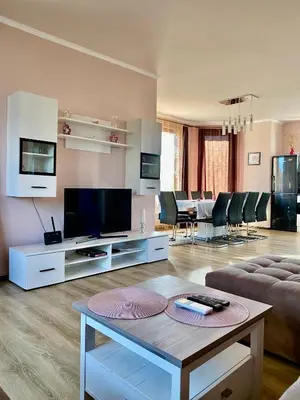 a living room with a couch and a tv at Rose Villa in Trŭstikovo
