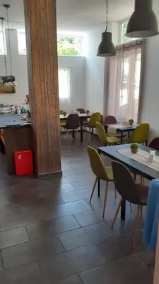 a dining room with tables and yellow chairs at Sunshine Byala 2 in Byala