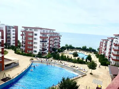 a view of a swimming pool and some apartment buildings at 17 pools in Fort Noks Grand in Sveti Vlas