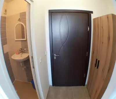 a black door in a bathroom with a sink at Sunshine Byala in Byala
