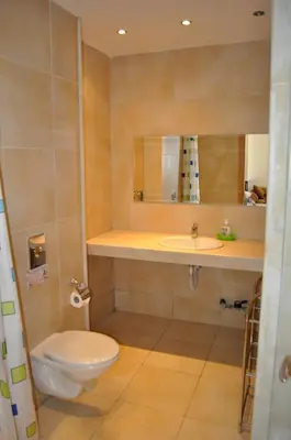a bathroom with a toilet and a sink and a mirror at Villa Sun Village Byala in Byala
