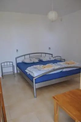 a bedroom with a bed and a wooden table at Villa Sun Village Byala in Byala