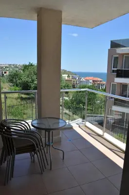 a balcony with a table and chairs and a view at Villa Sun Village Byala in Byala