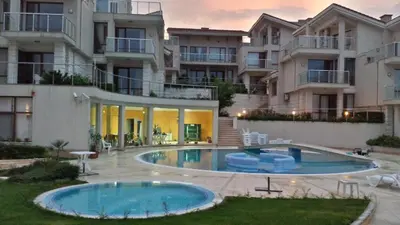 an apartment complex with a swimming pool in front of a building at Villa Sun Village Byala in Byala