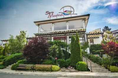 a building with a bench in front of it at Marina Trio in Sozopol