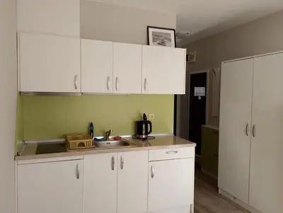 a kitchen with white cabinets and a sink at Sorrento Sole Mare Studio A Bastet BS in Sveti Vlas