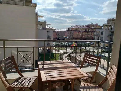 a wooden table and two chairs on a balcony at Sorrento Sole Mare Studio A Bastet BS in Sveti Vlas