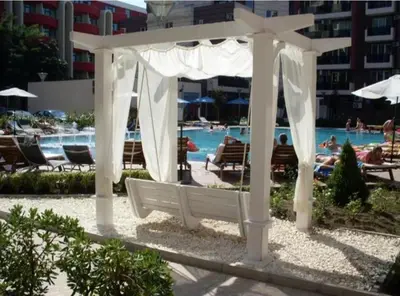 a white gazebo in front of a swimming pool at Privite apartment hotel Admiral plaza in Sunny Beach