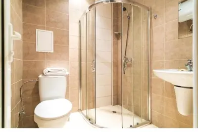 a bathroom with a shower and a toilet and a sink at Privite apartment hotel Admiral plaza in Sunny Beach