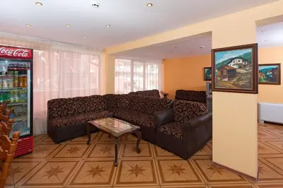 a living room with a couch and a soda machine at Hotel Smolyan in Sunny Beach